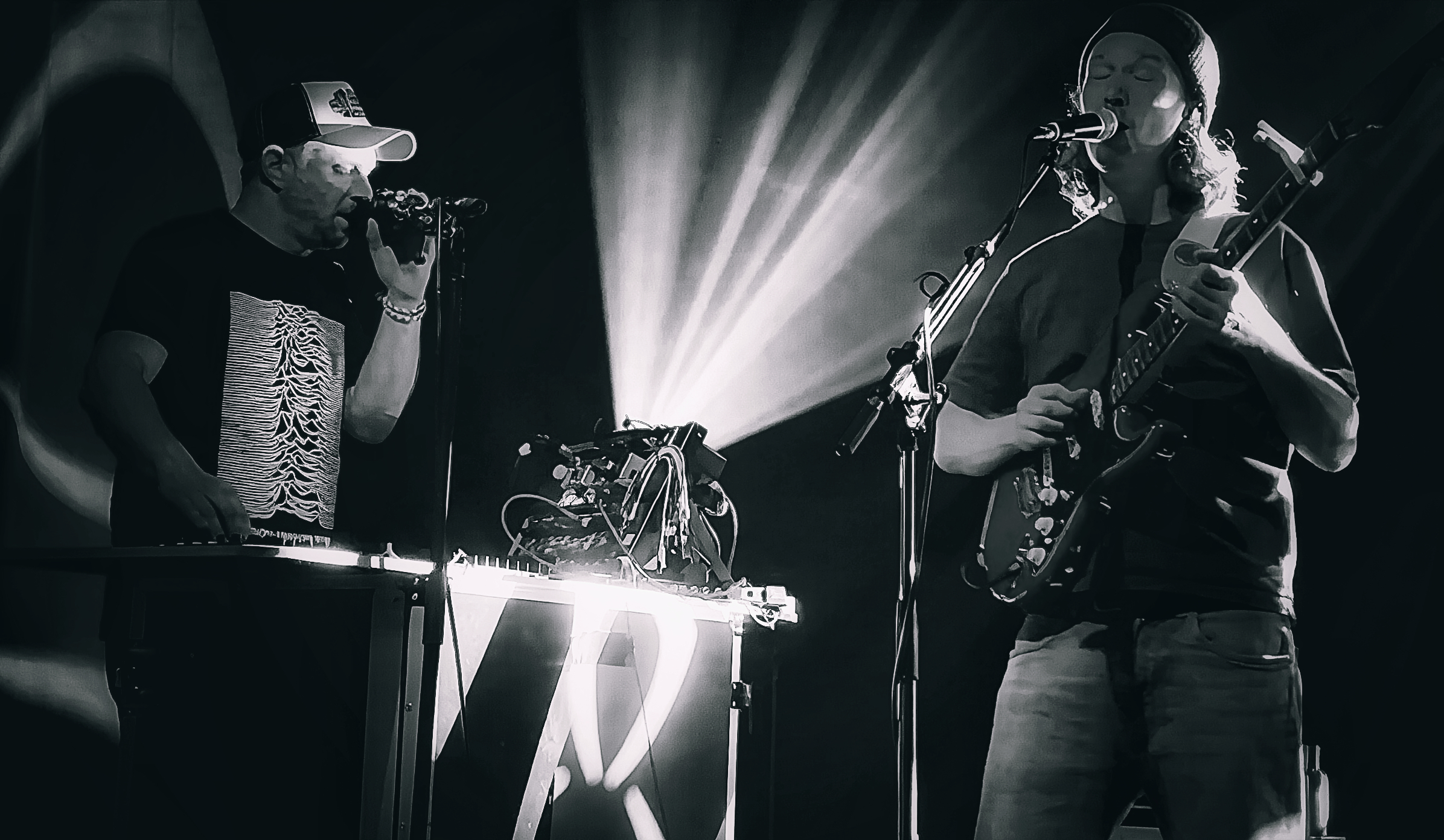 Duo performing under stage lights